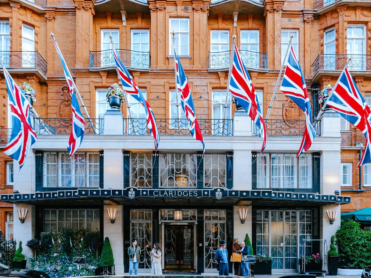 Union flags along the red-brick front of Claridge's on Brook Street, Mayfair
