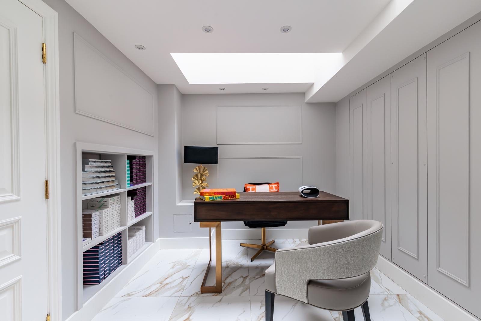 The consultation room at By Narjis: a desk and an armchair under a skylight